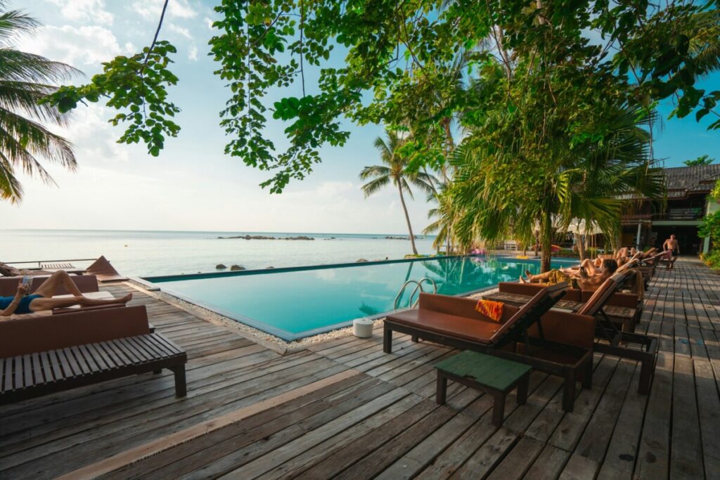 hotel pool with day bed overlooking the sea